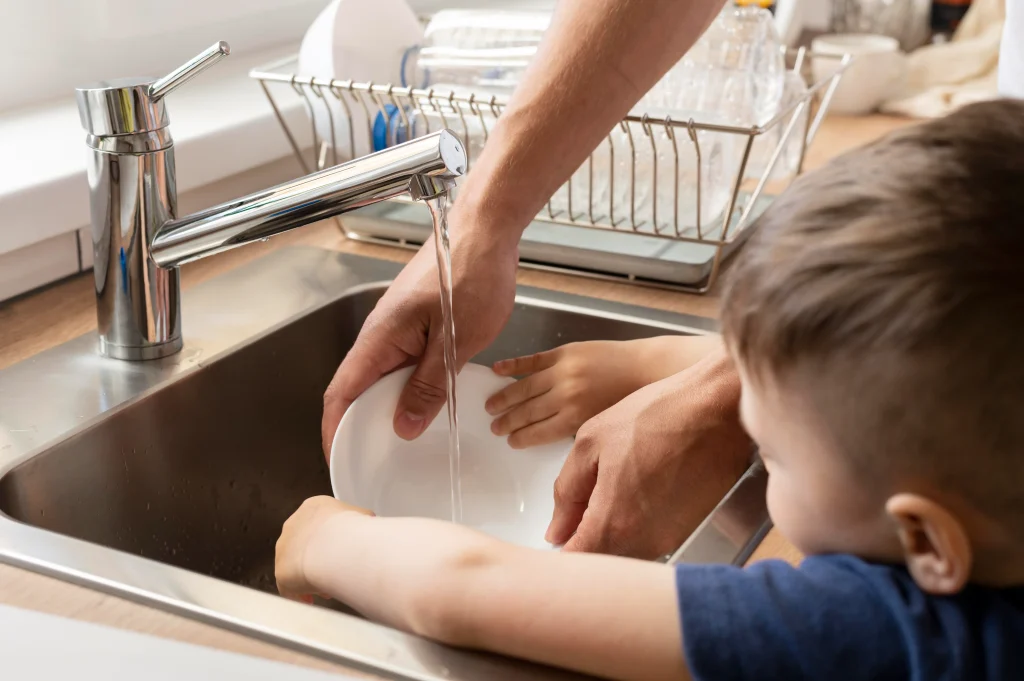 close up kid washing dish
